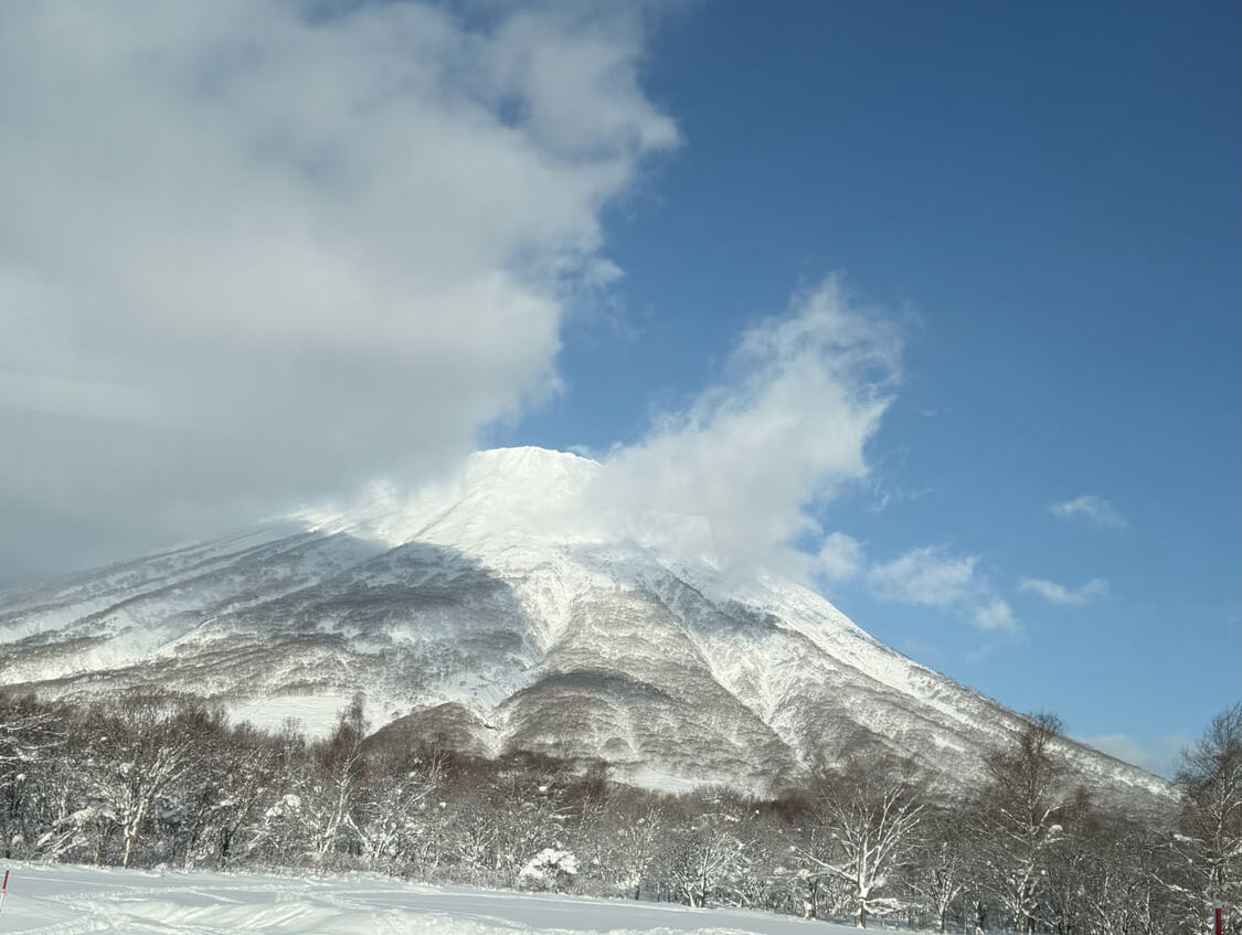 Niseko bluebird ski conditions with distant Mt. Yotei view captured during BSSC Japan ski vacation
