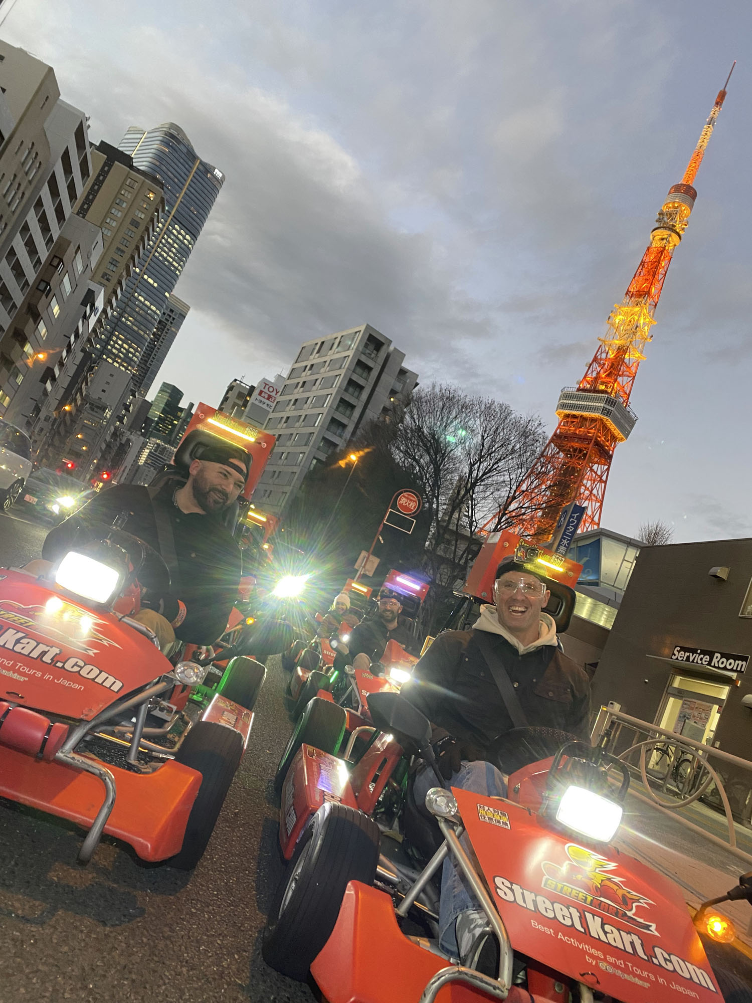 Group street kart adventure in Tokyo Bay with views of Rainbow Bridge and city landmarks on BSSC Japan 2026 trip.