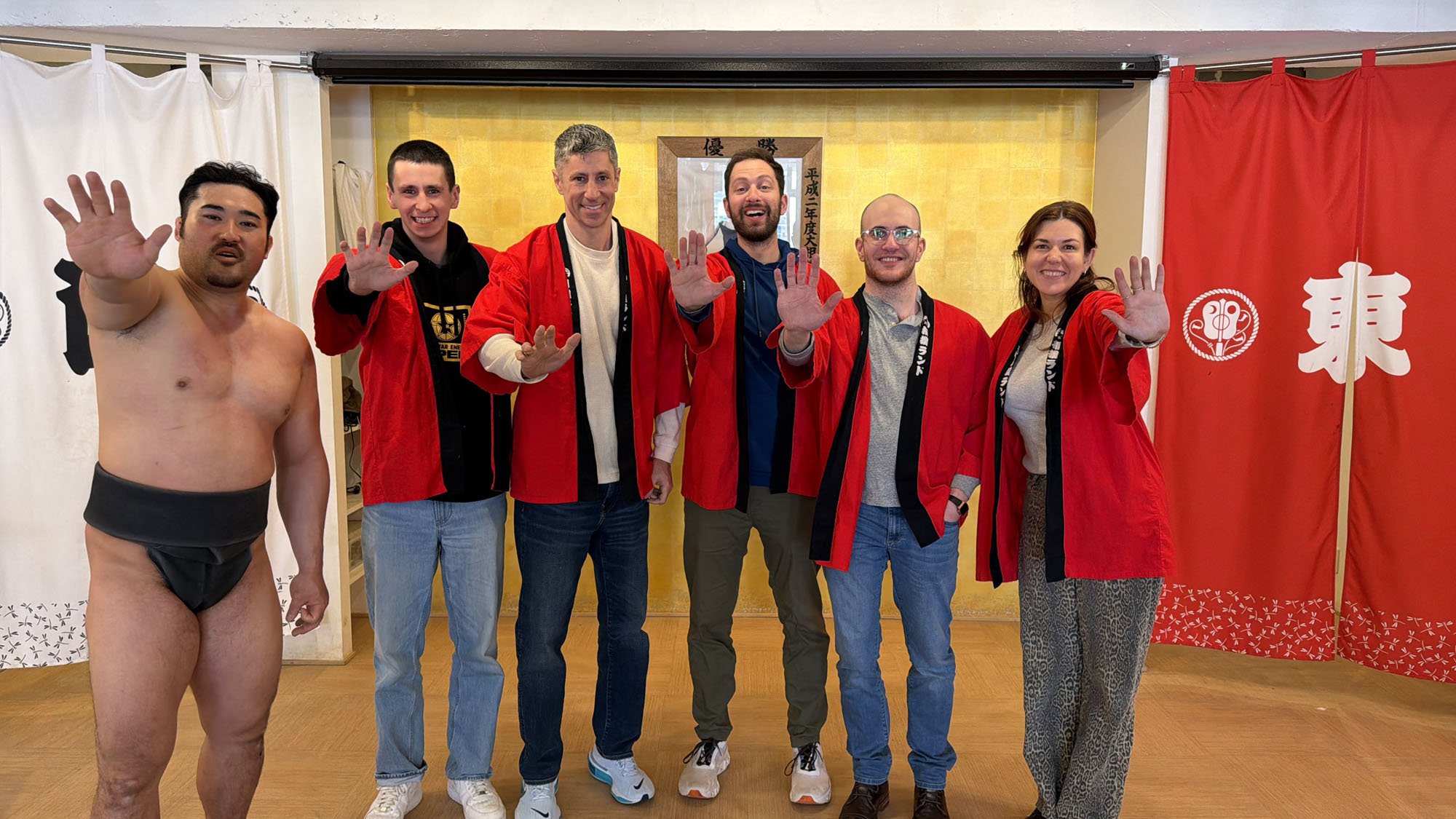 Visitors at Sumo Land Tokyo participating in sumo demonstrations and cultural activities on Japan ski vacation.